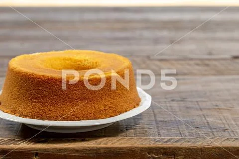 Cornmeal cake on rustic wooden table, bottom view. Stock Photos