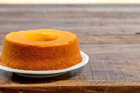 Cornmeal cake on rustic wooden table, bottom view. Stock Photos