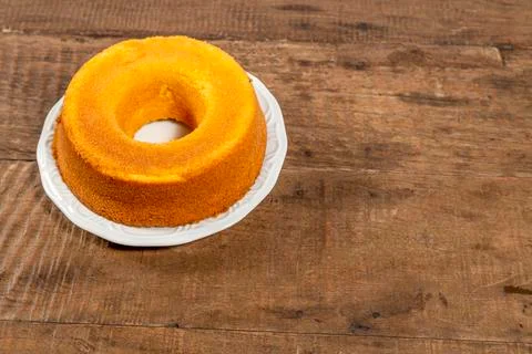 Cornmeal cake on rustic wooden table, top view and with space for text. Photo Stock Photos