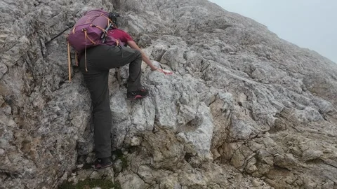 CORNO GRANDE, ITALY - AUGUST 22, 2024: Hiker climbing the crest of Gran Sasso Stock Footage 282520899