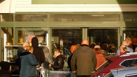 Cornona Covid virus shoppers panic buying waiting at store doors UK retail Video stock 126772354