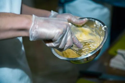 Corolla and broken eggs with flour mixing in bowl Foto stock
