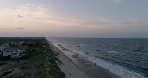 Corolla, NC beach coastline in the outer banks. Aerial drone shot at sunset. Video stock 135413925