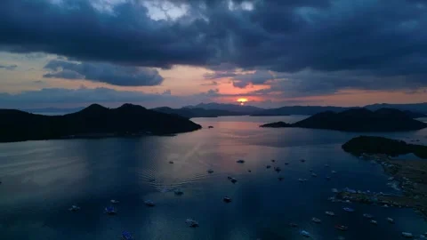 Coron Islands sunset with boats on tranquil water. Nice aerial view drone Stock Footage 344574366