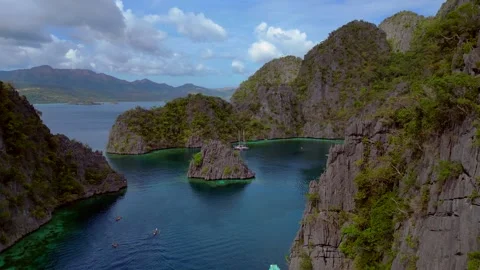 Coron limestone karsts, turquoise lagoons reflecting sky. Nice aerial view drone Stock Footage 344619246