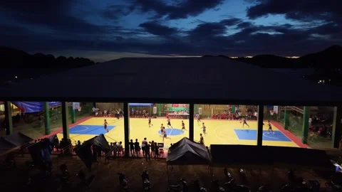 Coron, Philippines - Dec 13, 2025: Christmas basketball tournament at dusk Stock Footage 325794762
