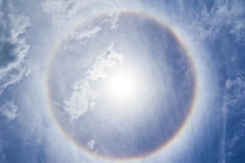 Corona on blue sky, ring around the sun Stock Photos