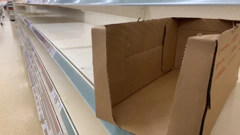 Corona virus: Empty box on empty supermarket shelves panic buying stockpiling UK Stock-Footage 126877704