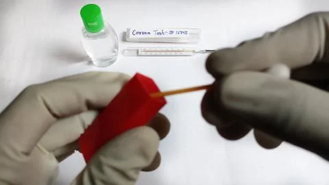 Corona Virus testing kit in hands on lab table Stock Photos