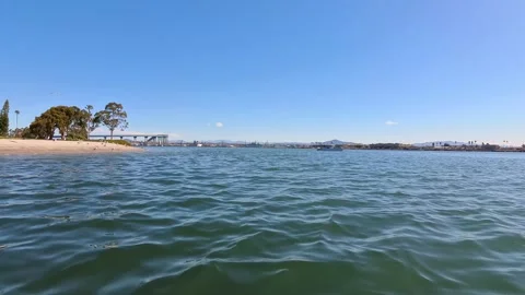 Coronado Glorietta Bay view with sandy beach and distant bridge under clear sky Stock Footage 331614940