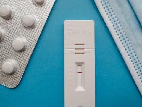 Coronavirus antigen test with a negative result on a blue bright background next Stock Photos
