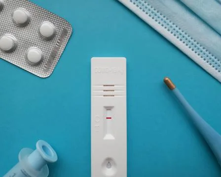 Coronavirus antigen test with a negative result on a blue bright background next Stock Photos