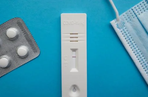 Coronavirus antigen test with a negative result on a blue bright background next Stock Photos