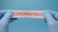 Coronavirus Background. Hands In Medical Gloves Hold A Piece Of Paper With Stock Footage
