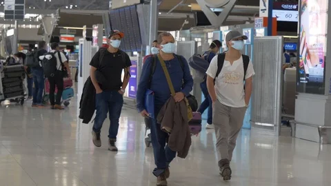 Coronavirus Bangkok airport Asian tourists wearing surgical masks against virus Stock Footage