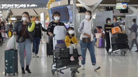 Coronavirus Bangkok airport Asian tourists wearing surgical masks against virus Stock Footage