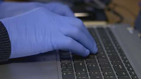 Coronavirus Close-up of man hands in gloves typing on laptop keyboard. Stock Footage 129510147