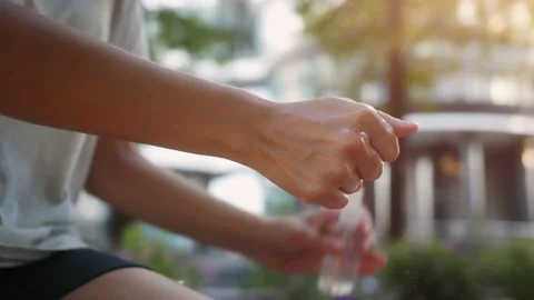 Coronavirus concept. Person outdoor using sanitizer spray. Stock Footage 156401072