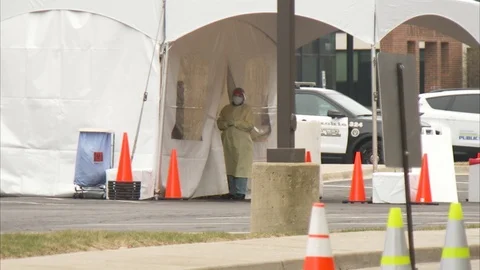 Coronavirus Covid-19 drive thru testing center with medical staff in masks Stock-Footage 127211253