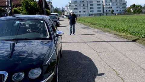 Coronavirus. the driver gets out of the car and puts on a mask Stock Footage 132174679