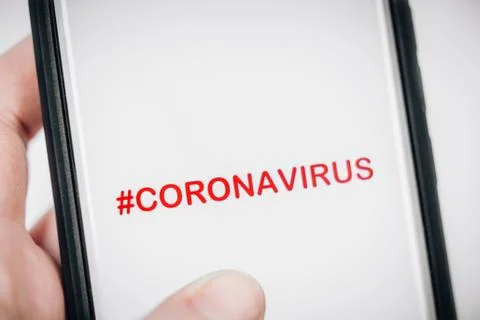 CORONAVIRUS HASHTAG ON SMARTPHONE SCREEN Stock Photos