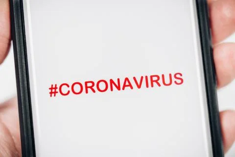 CORONAVIRUS HASHTAG ON SMARTPHONE SCREEN Stock Photos