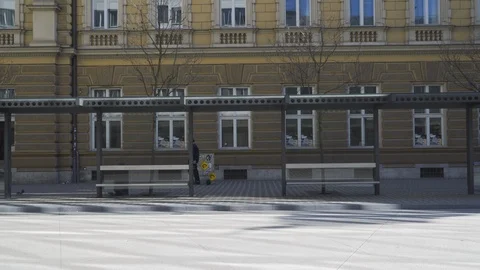 Coronavirus lockdown, Empty BUS stops, no passengers. Postman passing by. Stock Footage 126579060