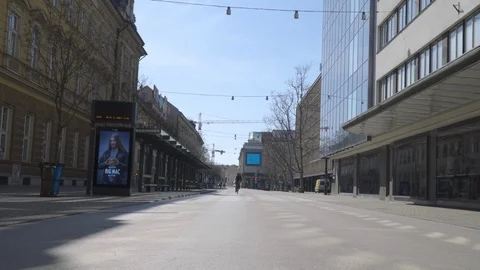 Coronavirus lockdown, Empy main street with cyclist passing by. Stock Footage 126578249