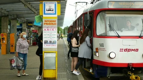 Coronavirus mask face tram stop tram crowd girls streetcar tram-car Stock Footage 134084499