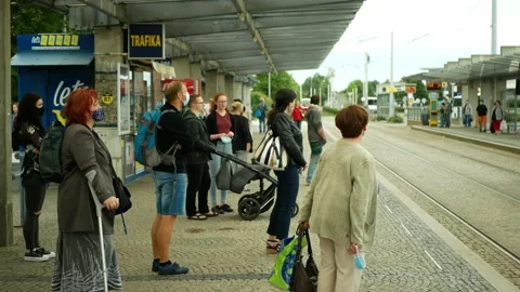 Coronavirus mask face tram stop tram crowd woman streetcar tram-car Stock Footage 135474904