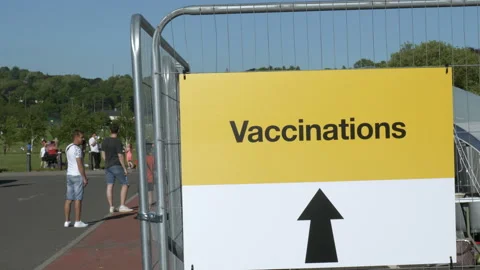 Coronavirus mass vaccination programme 2021. People queueing for a Stock Footage 155626683