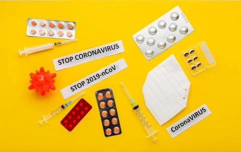 Coronavirus model, protective mask, different pills, syringes, filters for no Stock Photos