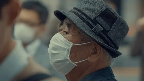 CORONAVIRUS : Old Asian Man Wearing Face mask in city in Slow Motion Stock Footage