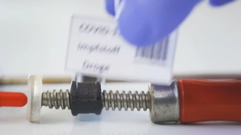 The coronavirus or Covid-19 Impfstoff Droge written in German red capsule Stock Footage 129336725