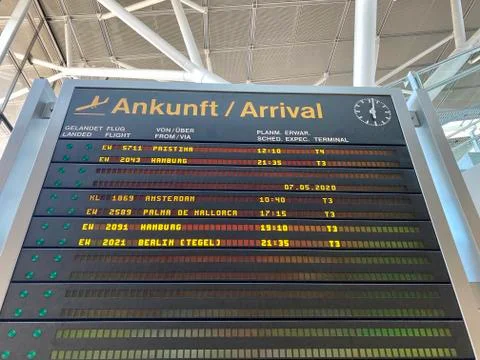 Coronavirus outbreak: Almost empty arrival board at the airport terminal due to Stock Photos