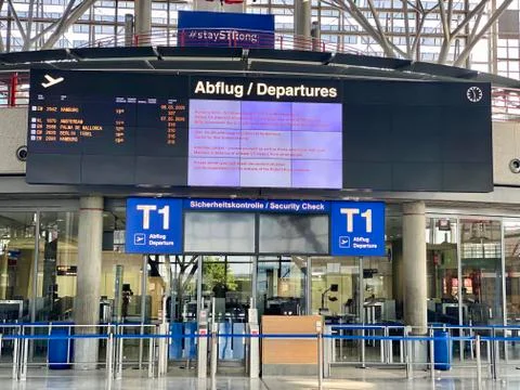Coronavirus outbreak: Almost empty departure board and closed check in at the Stock Photos