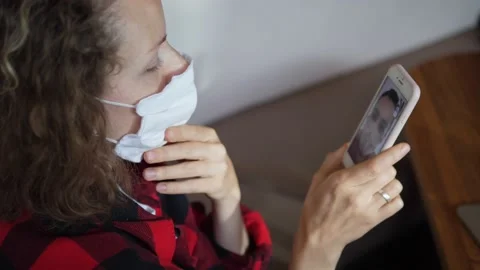 Coronavirus outbreak concept. Close up of long distance video call between two Stock Footage 141519977