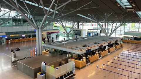 Coronavirus outbreak: Empty check-in desks at the airport terminal due to Stock Footage 130338482
