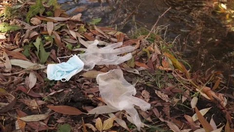 Coronavirus outbreak - garbage, disposable masks in water, river, lake Stock Footage 142452761