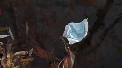 Coronavirus outbreak - garbage, disposable masks in water, river, lake Stock Footage 142454085