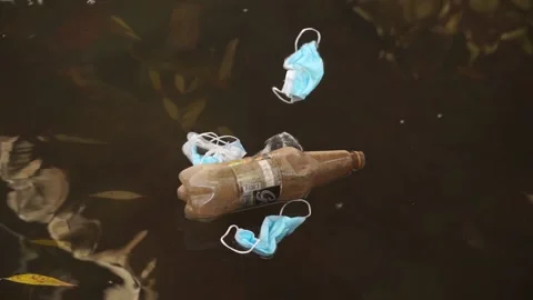 Coronavirus outbreak - garbage, disposable masks in water, river, lake Stock Footage 142454590