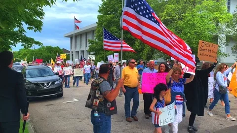 Coronavirus outbreak: hundreds protest COVID-19 lockdown measures in Raleigh NC Stock Footage 128847669