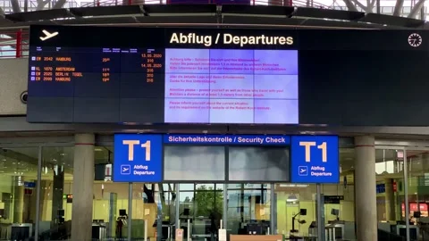 Coronavirus outbreak: Panning from almost empty departure board over closed Stock Footage 130339118