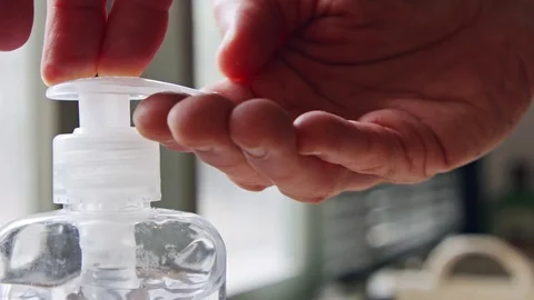 Coronavirus pandemic close up on hands using hand sanitizer to prevent infection Stock Footage 126611035