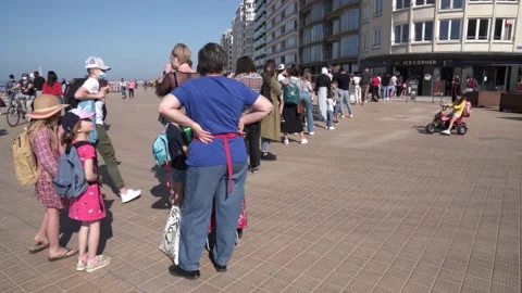 Coronavirus pandemic concept. Long queue to get an ice cream on the Stock Footage 152803609
