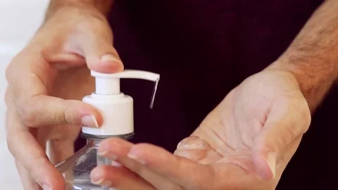 Coronavirus prevention. Man using alcohol gel for hand hygiene. Covid-19. Stock Footage 133599983