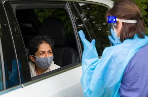 Coronavirus prevention at UK testing centre, Asian woman Stock Photos