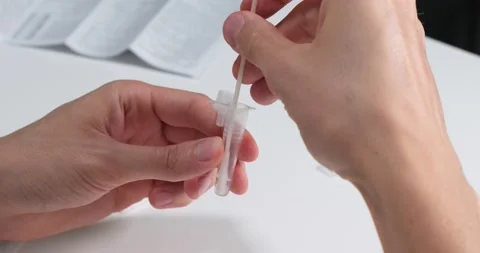 Coronavirus rapid self test, nasal swab in the tube with liquid. Video stock 155074172