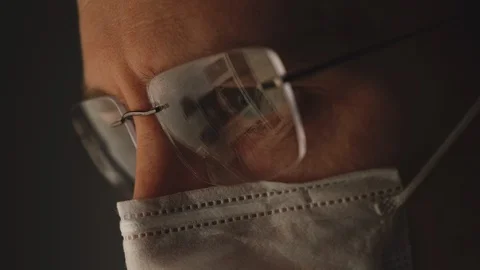 CORONAVIRUS: Reflection at the glasses. Man put on a mask Stock Footage 126708502