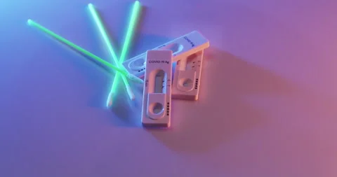 Coronavirus Test Kit with probe. Antigen test under blue and orange light Stock Footage 172135680
